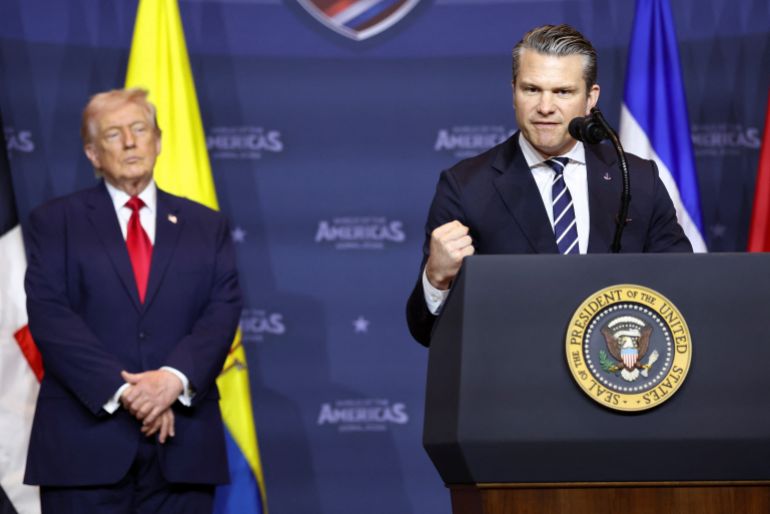 U.S. Secretary of Defense Pete Hegseth speaks next to U.S. President Donald Trump during the "Shield of the Americas" Summit in Miami, Florida, U.S., March 7, 2026. REUTERS/Kevin Lamarque