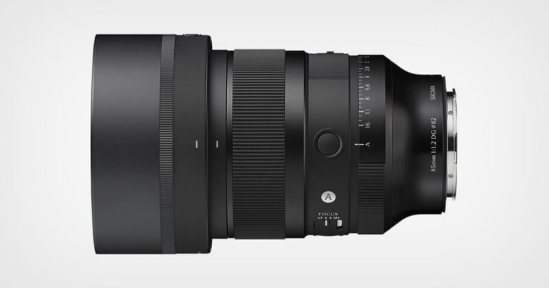 Side view of a black Sigma camera lens with focus and aperture rings, switches, and markings visible on its body against a plain white background.