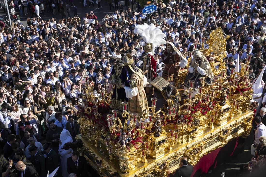 The brotherhood of San Gonzalo crosses the Isabel II bridge on their way to the cathedral on the second official day of the Holy Week celebrations at Sevilla, Spain on March 30.