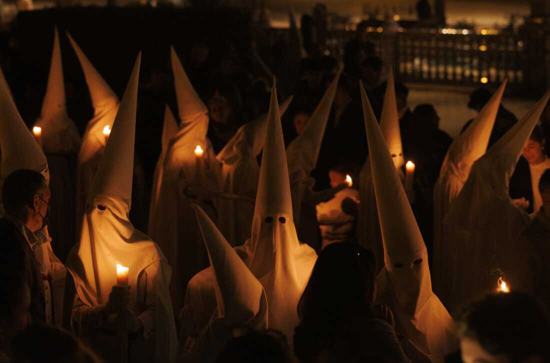 Penitents of La Paz (The Peace) brotherhood take part in a procession during Holy Week (Semana Santa) observances on March 29, 2026 in Seville, Spain.