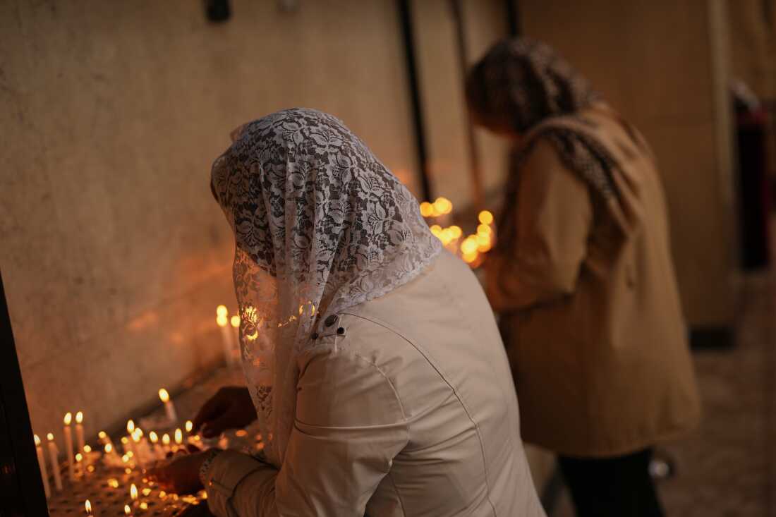 Worshippers light candles during Easter Sunday Mass at Saint Sarkis Cathedral, an Armenian Apostolic church, in Tehran, Iran, Sunday, April 5, 2026. 