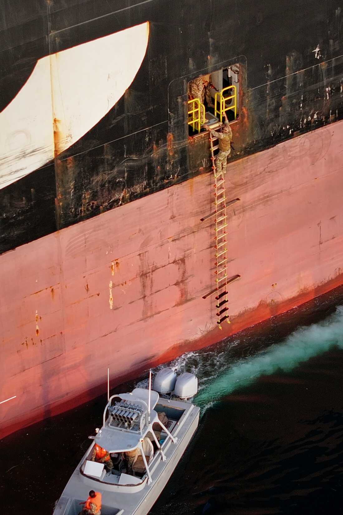 In this photo released by Tasnim News Agency, Revolutionary Guard Navy armed men climb aboard the cargo ship MSC Francesca during what state media described as the seizure of one of two vessels accused of violations in the Strait of Hormuz, on April 21.