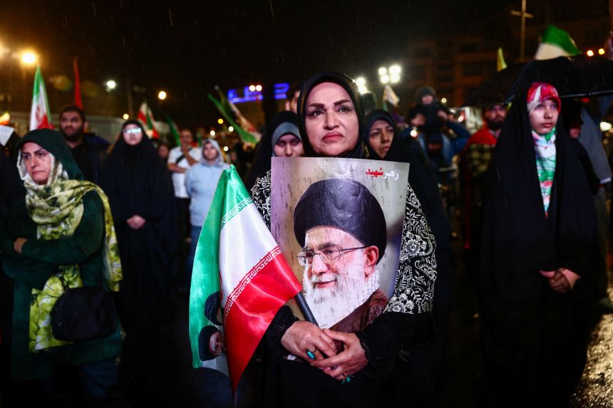 A woman holds a poster of Iran’s late Supreme Leader Ayatollah Ali Khamenei during an anti-US and anti-Israel rally, amid a ceasefire between U.S. and Iran, in Tehran, Iran, on April 19.