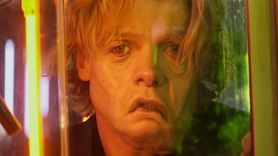 Matt Hagen's face melting through store window in Clayface 