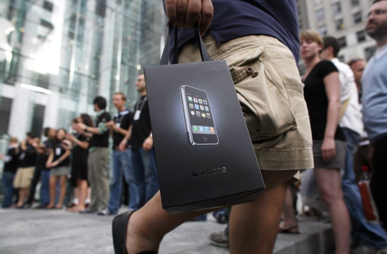 New iPhone owners exit Apple's flagship store on Fifth Avenue on June 29, 2007 in New York City.