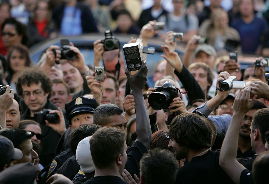 The first customer in line holds up his new Apple iPhone after purchasing it at an Apple store June 29, 2007 in San Francisco, California.