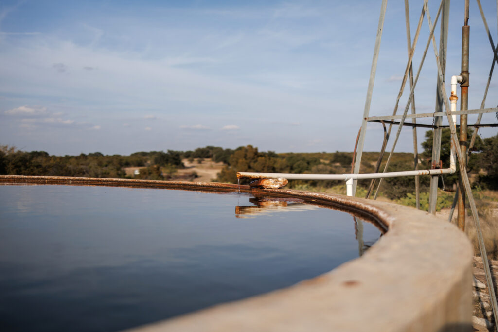 A windmill supplies water on Jackie Chesnutt’s property. She worries that pollution from oil wells could pollute the groundwater she relies on.