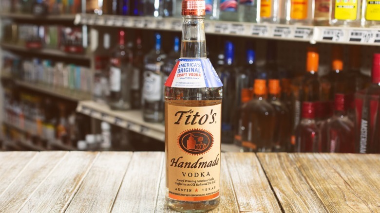 A bottle of Tito's vodka on a store counter